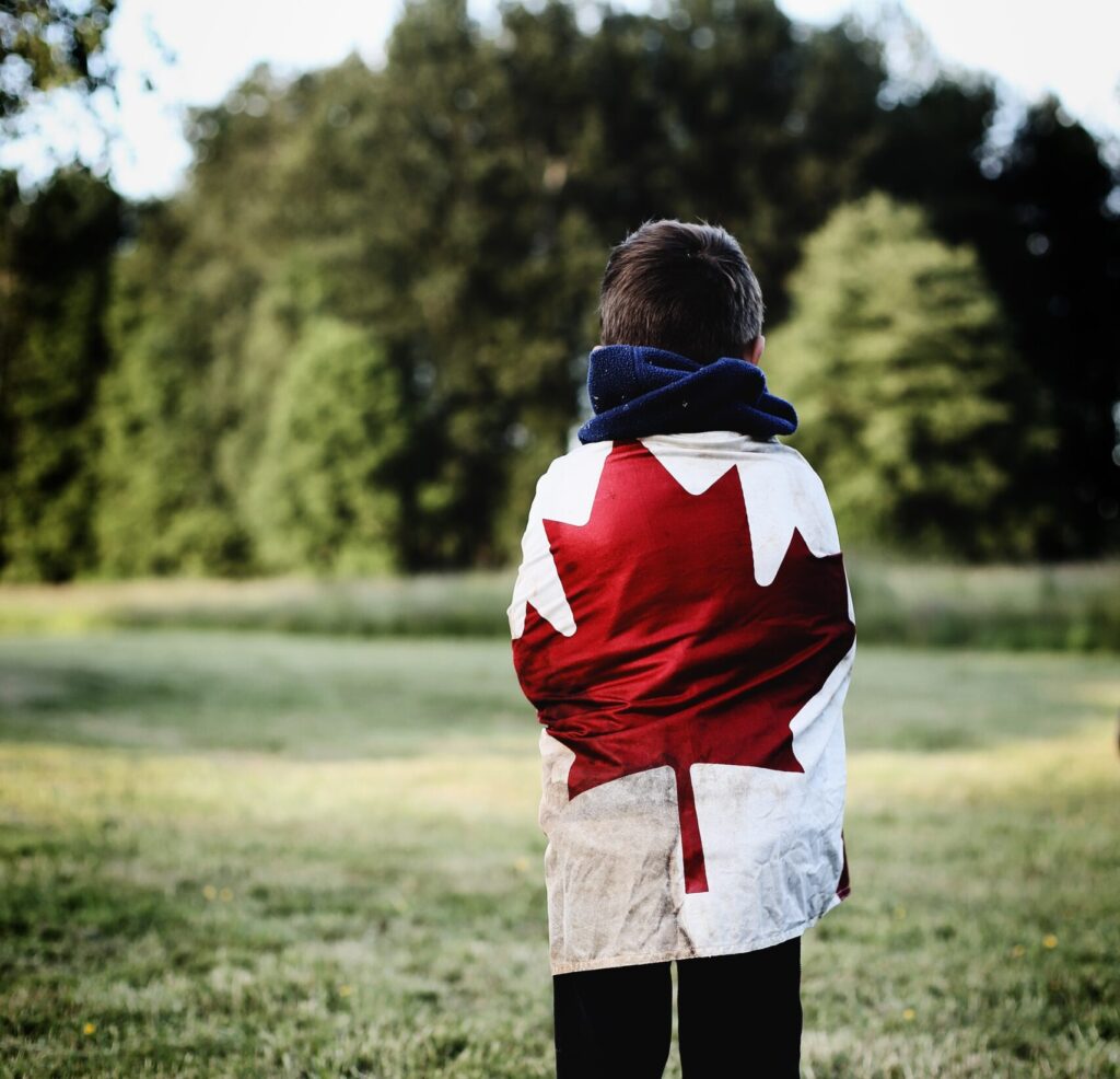 Photo of child with Canadian flag by Ksenia Makagonova on Unsplash